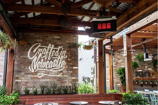 Restaurant exterior featuring a stylish gas outdoor heater and cosy ambiance.