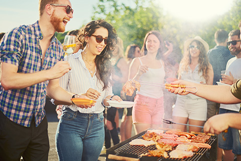 Group of friends outdoors enjoying a barbecue, symbolising community and gas use in social settings.