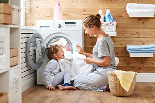 Family relaxing as a gas-powered dryer dries their laundry