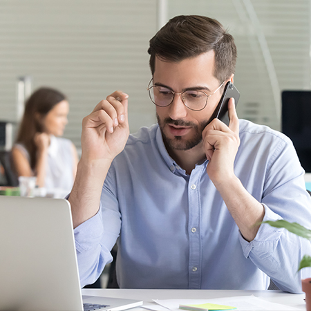 Man working at his desk reviewing energy-related data and reports.