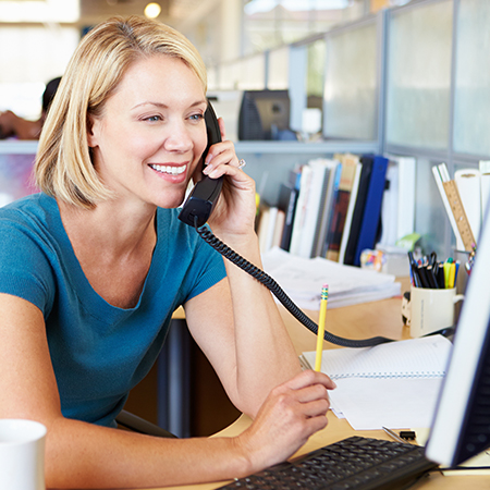 Smiling customer service representative assisting with energy inquiries.