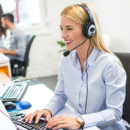 Customer service representative wearing a headset assisting clients with gas inquiries.