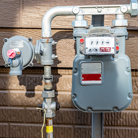 Gas meter installed on a brick wall, symbolising residential/commercial gas supply infrastructure.