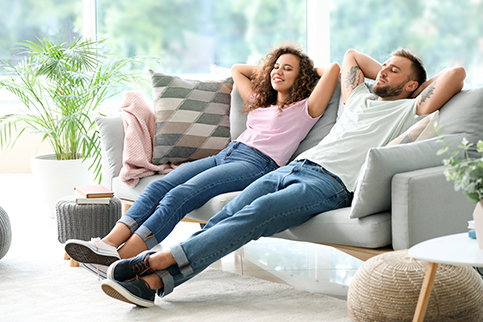 Family relaxing in a cosy living room with gas heater providing warmth.